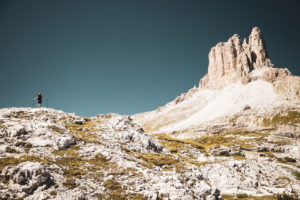 Female mountaineer, view of Tre Cime di Lavaredo Plateau from Innerfeldtal Valley, Dolomites, South Tyrol, Italy Female mountaineer, view of Tre Cime di Lavaredo Plateau from Innerfeldtal Valley, Dolomites, South Tyrol, Italy
